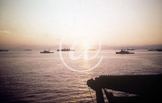 inconnu() Seconde guerre mondiale US Navy en couleurs - Srie 80-GK- : De nombreux batiments voluent dans le couch du soleil.