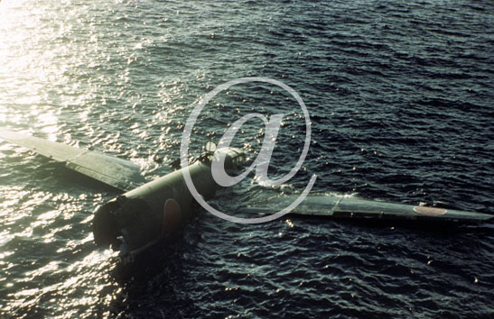 inconnu() Seconde guerre mondiale US Navy en couleurs - Srie 80-GK- : Un avion japonais abattu par la DCA flotte encore dans l