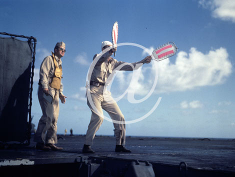 inconnu() Seconde guerre mondiale US Navy en couleurs - Srie 80-GK- : Un matelot oprateur brandit ses fanions signaltiques sur une piste d